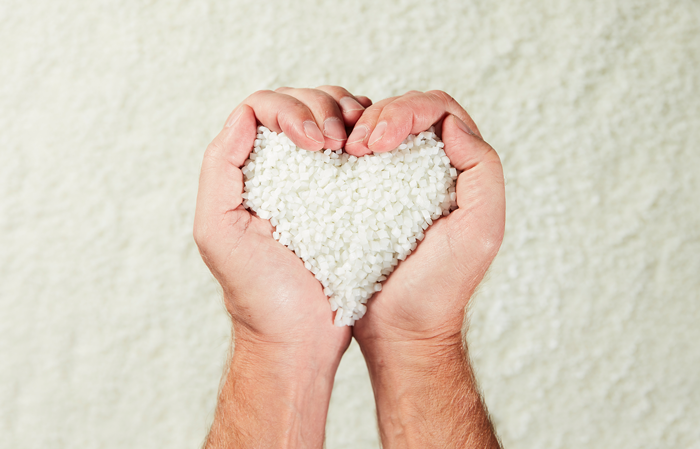 Male hands, heart shaped holding white granulates